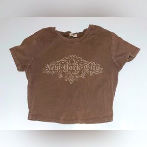Brown Garage crop top. “New York City” written